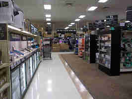 A walkway in Micro Center. To the left are demo tablets, and to the right are shelves with peripherals. In the background is the store's DIY PC section.