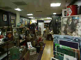 A room in the Glenwood antique mall. Shelves in the middle hold various collectibles, with more collectibles lining the walls.