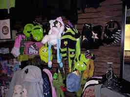 Invader Zim and Hello Kitty merch hanging from a wall in the Zona Rosa Hot Topic. The merch is lit by my camera's flash, which I forgot to turn off.